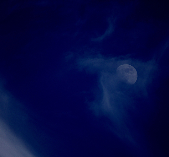 Moon sinking into the spell of the clouds